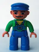 Minifigurka: 47394PB048:  Duplo Figure Lego Ville, Male, Blue Legs, Green Top with Yellow Scarf, Blue Cap, Curly Moustache (Train Engineer)